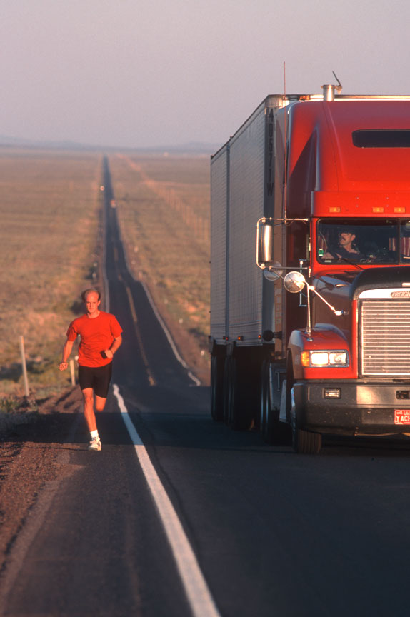 Red truck on Oregon highway with runner