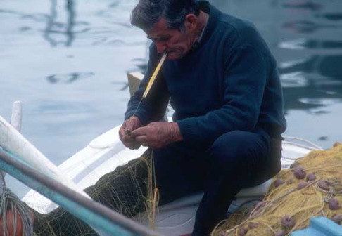 Greece, fisherman mending nets, Monevassia