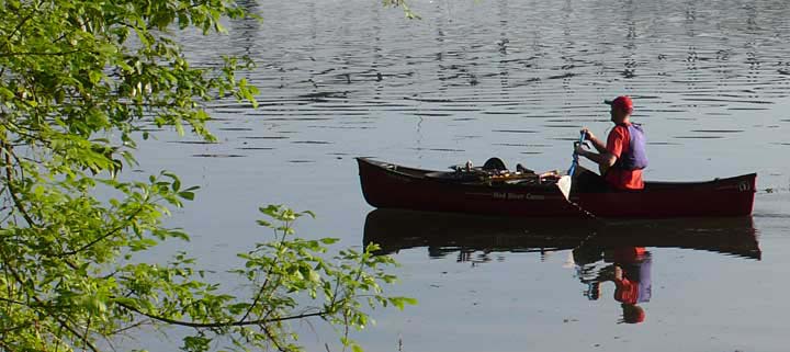 Canoe paddler on Willamette River, Portland, Oregon